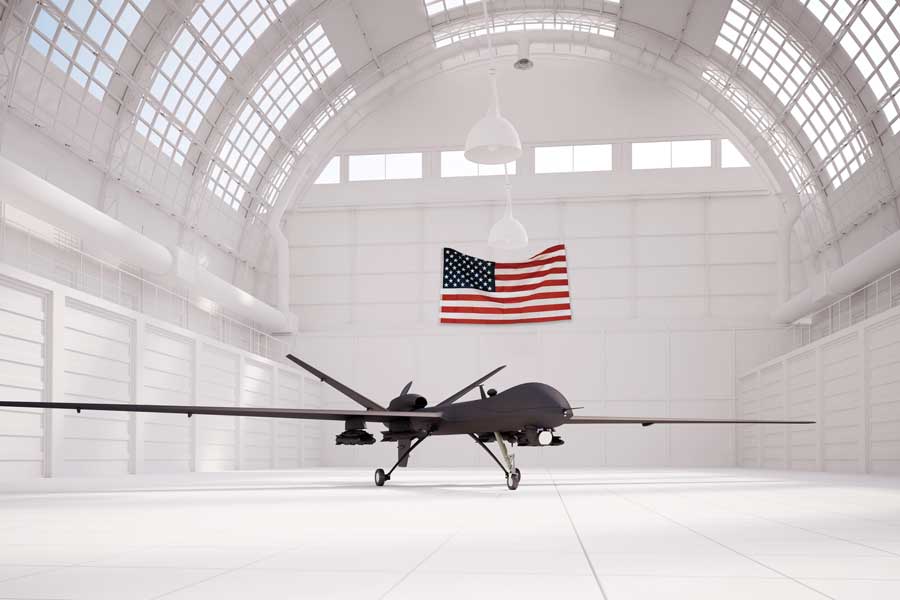 drone in white hanger with US flag hanging in background