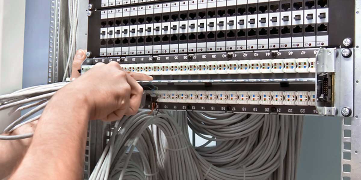 person at a network cabling station setting up network connections